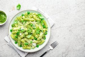 Healthy lifestyle eating vegetables including green peas in pasta