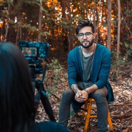Photo of a Man Sitting in Front of a Camera - now hiring