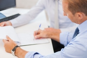 Man writing on notepad - salesman jobs