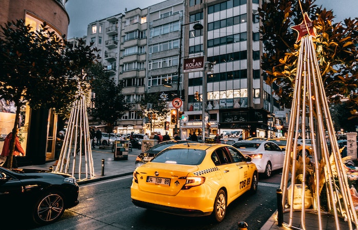 Taxi car and vehicles driving on city road - best Christmas towns in the US