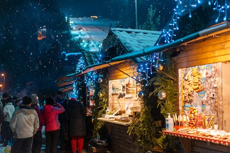 People walking at Christmas market in winter - best Christmas towns in the US