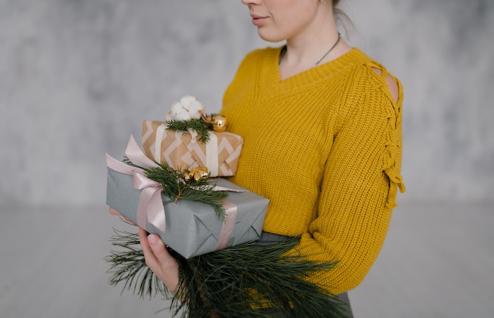 A Woman in Yellow Sweater Holding Gift Boxes - gifts for mom who doesn't want anything