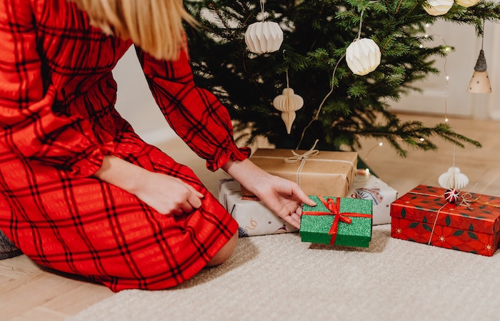 Person in Red and Black Plaid Dress Sitting on Floor With Green and Red Box on the Christmas Tree - creative gifts for wife