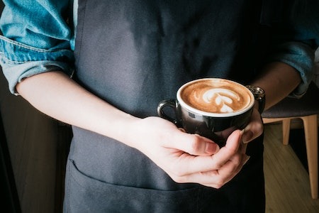 Woman Holding Mug of Cappuccino - part time evening jobs