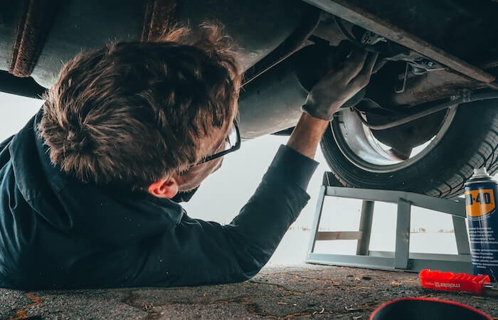 Man Fixing Vehicle Engine - preparing car for road trip