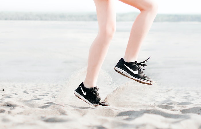 Photo of Woman Wearing Pair of Black Nike Running Shoes - best marathon running shoes