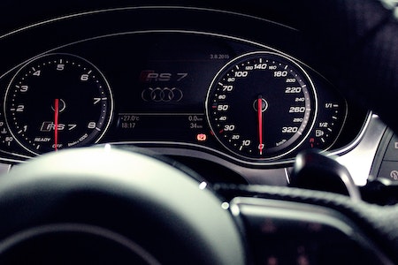 Person Showing Audi Rs 7 Speedometer - car signs on dashboard